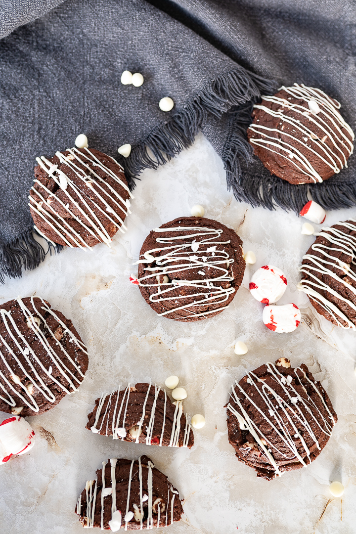 Chocolate peppermint cookies on the counter with white chocolate chips.