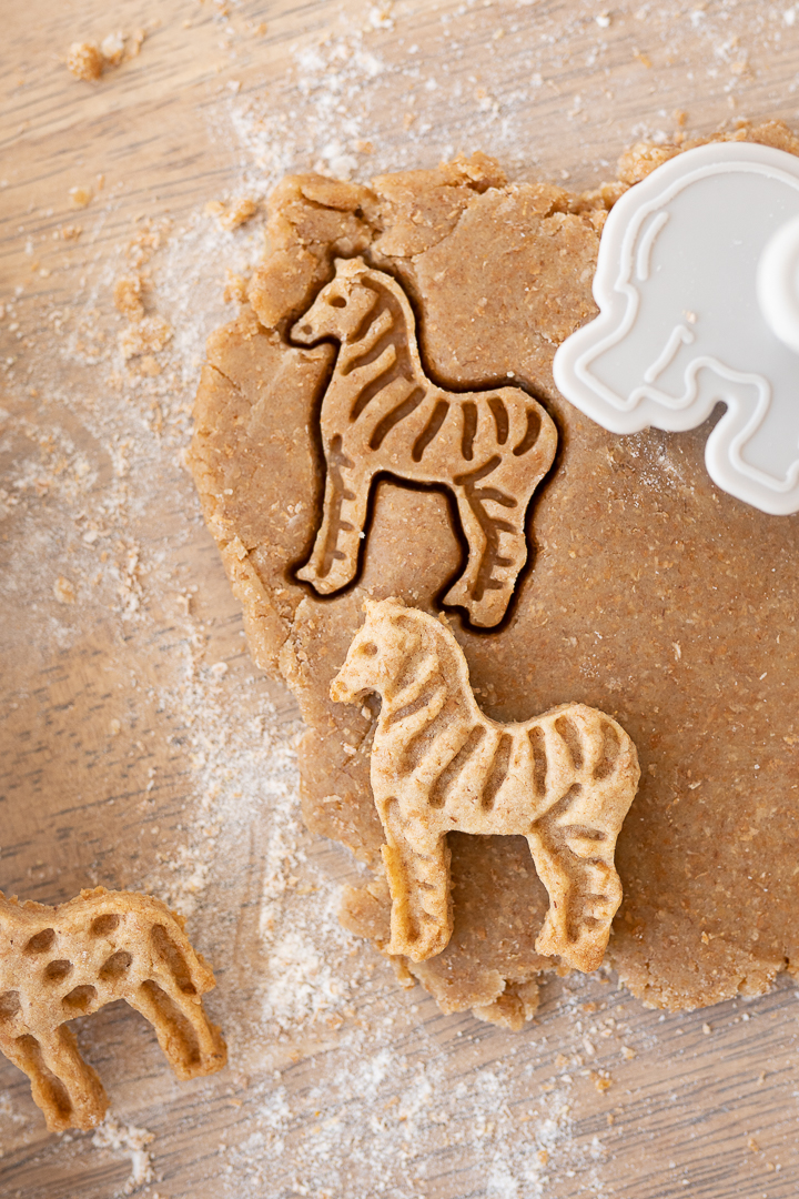 Animal cookie dough on the counter with a zebra cookie cut out.