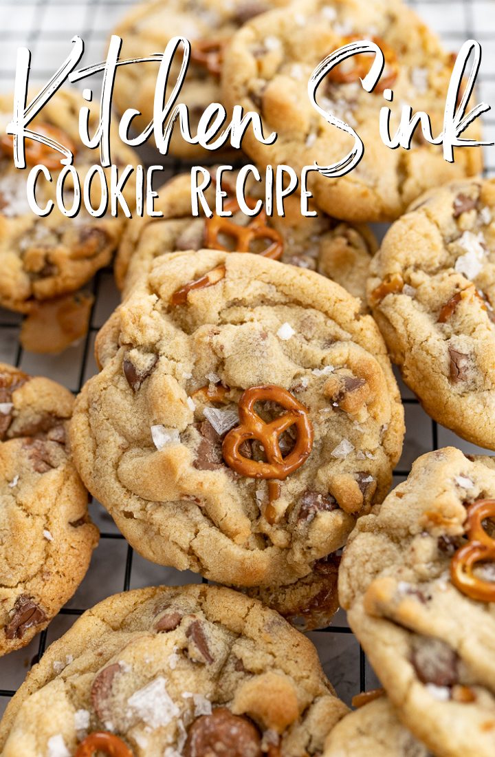 Large kitchen sink cookies on a cooling rack with text on the photo that reads "kitchen sink cookie recipe."