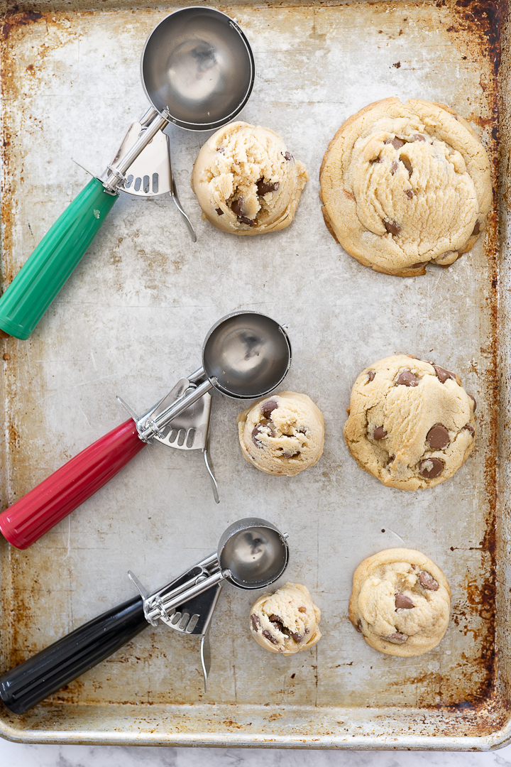 different cookie scoops with each size result on a cookie sheet.