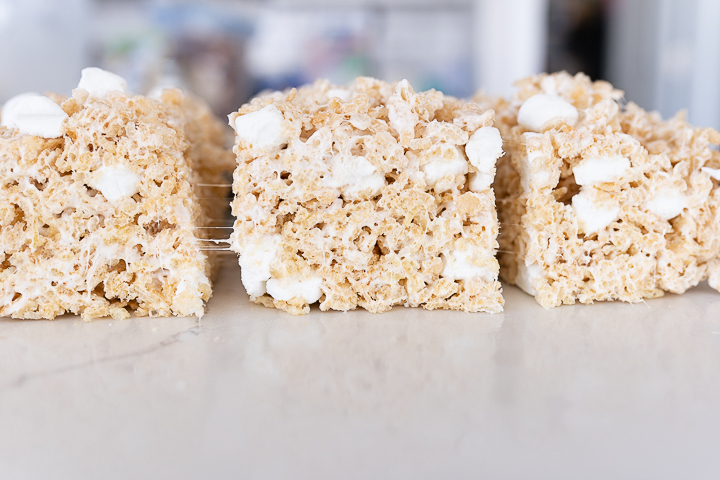 3 brown butter rice krispy treats lined up on a counter. 