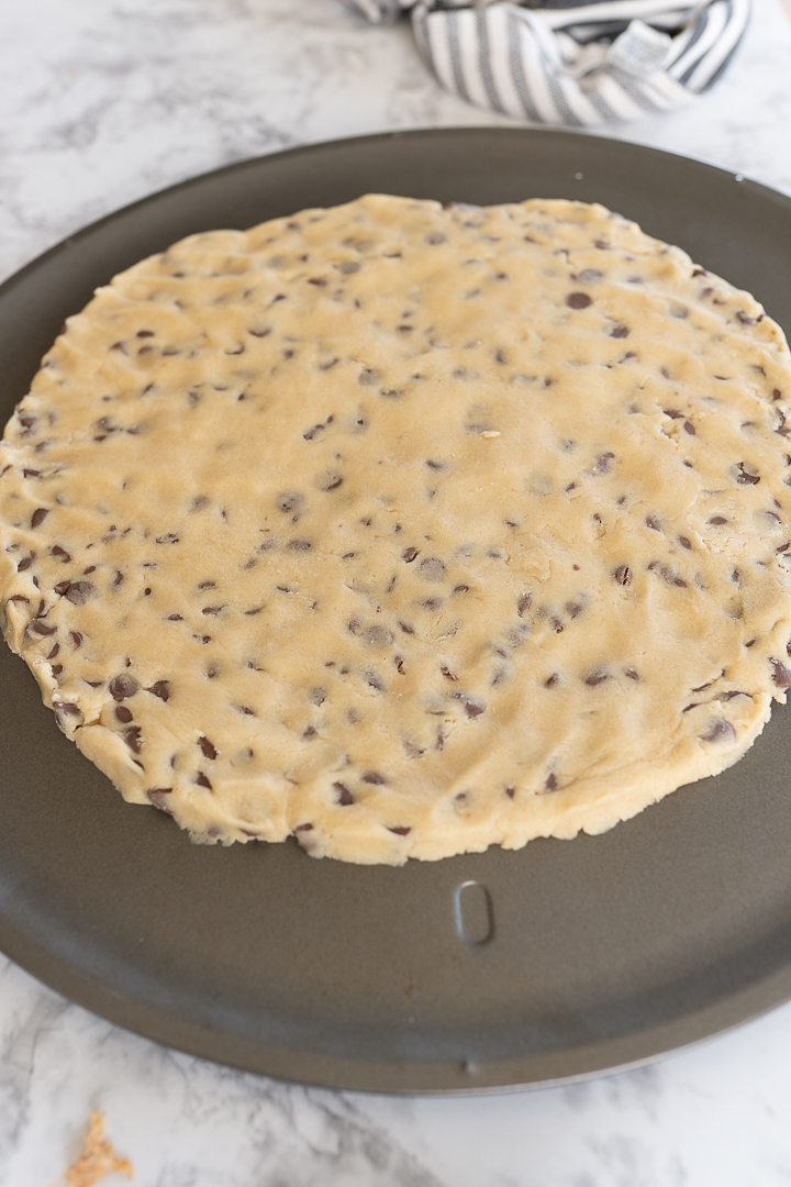 Flattened cookie dough on a pan, waiting to be baked. 