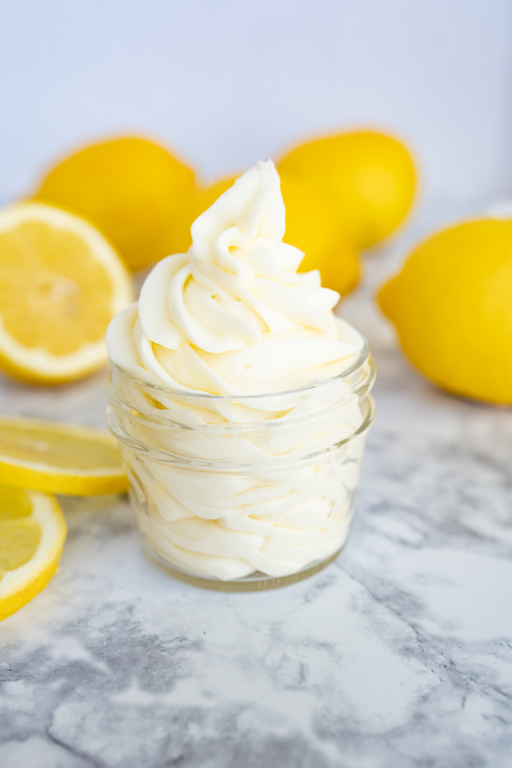 Lemon cream cheese frosting piped into a clear mason jar. 