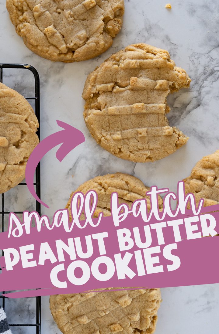 A counter top with peanut butter cookies sitting next to a wire cooling rack. One of the cookies has a bite taken out of it. Across the image are the words "small batch peanut butter cookies"