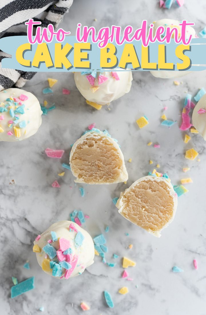 Cake balls scattered on a counter. One cake ball is sliced in half with the interior facing up. Across the top it says "two ingredient cake balls"