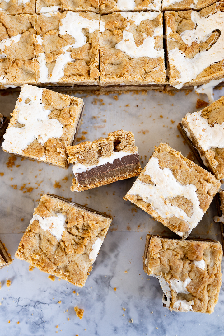 Smores bars cut into squares and arranged on a counter.