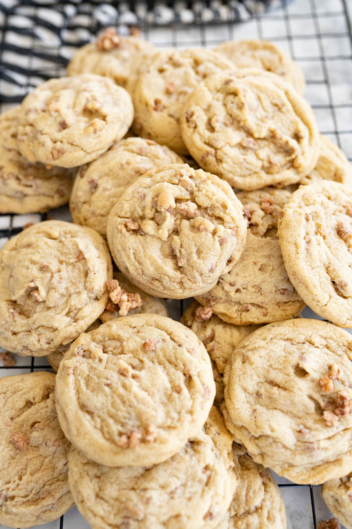 Butter pecan cookies piled high on a counter. 