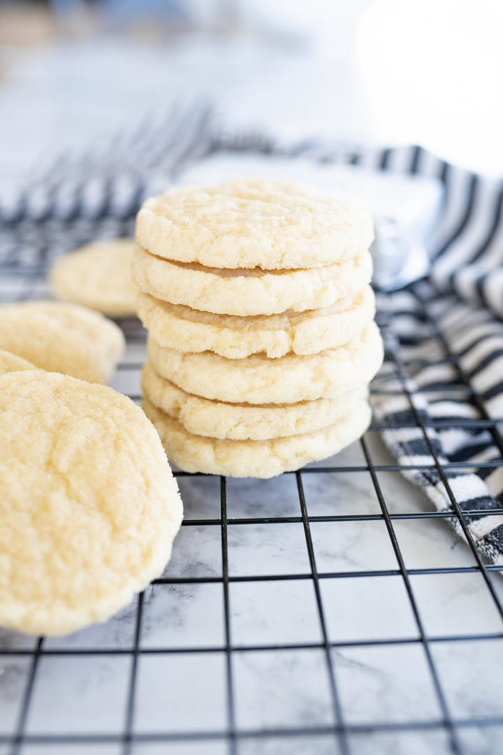 A stack of cheesecake cookies on a wire cooling rack. 