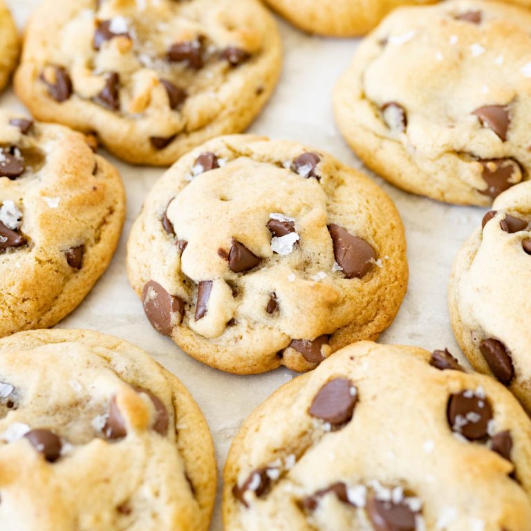 A counter full of chewy chocolate chip cookies.