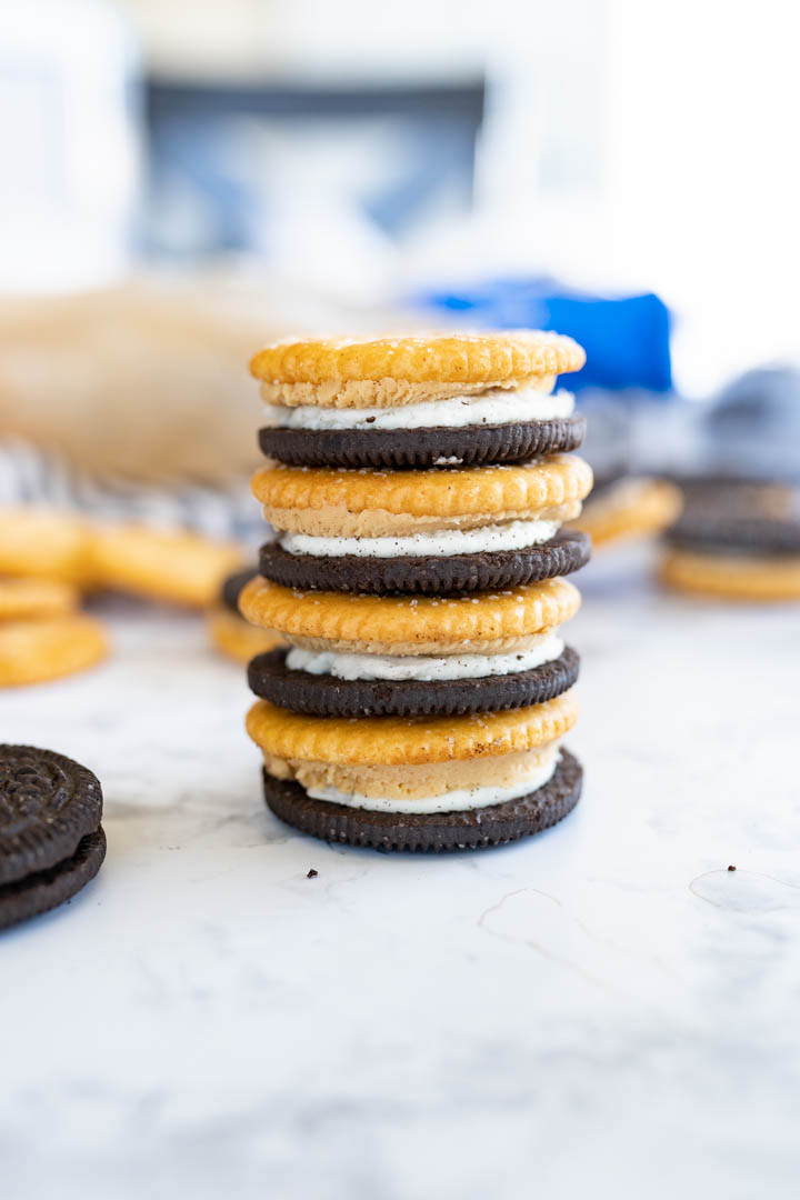 A tower of oreo ritz sandwiches with peanut butter filling stacked on a counter. 