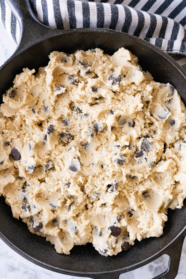 Cookie dough pressed into a skillet prior to being baked. 