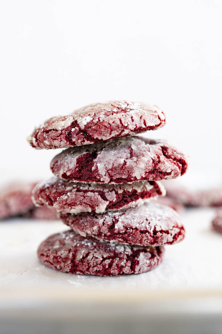 An off-kilter stack of red velvet crinkle cookies. 