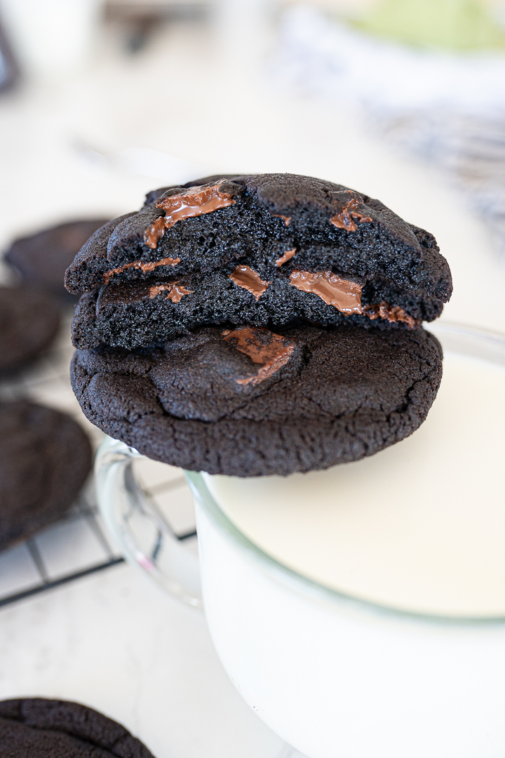 A double chocolate insomnia copycat cookie broken in half with the inside of the cookie facing out. 