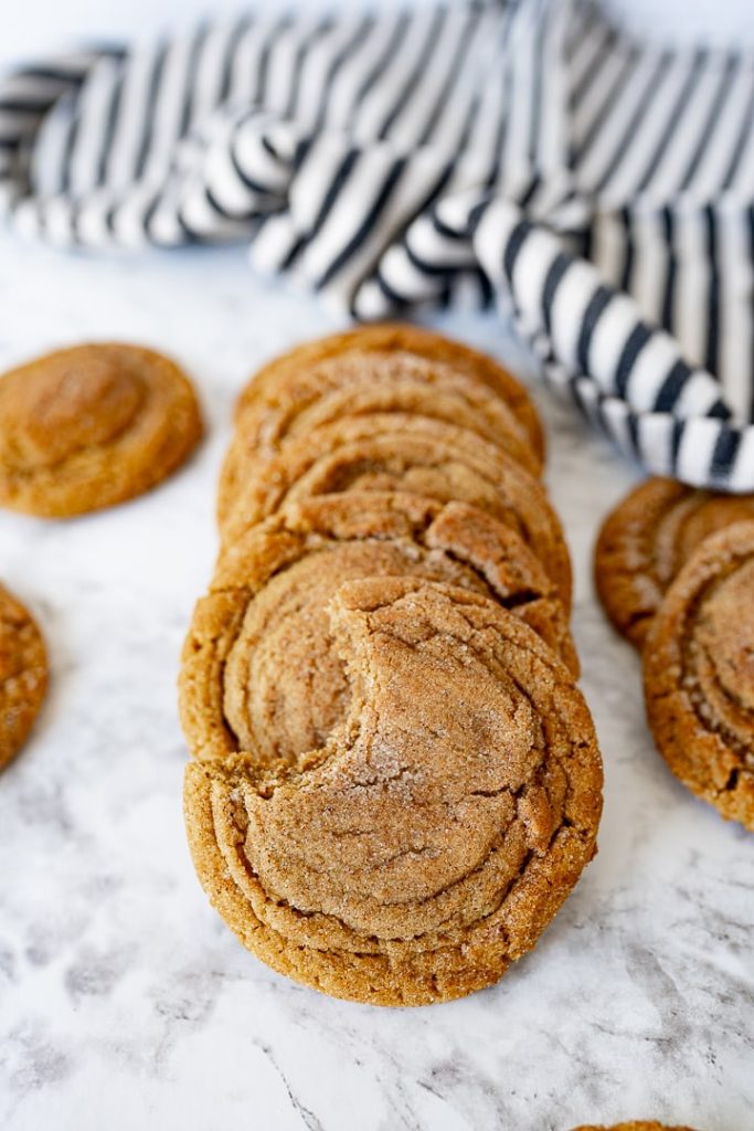A horizontal stack of gingersnap cookies on the counter. 
