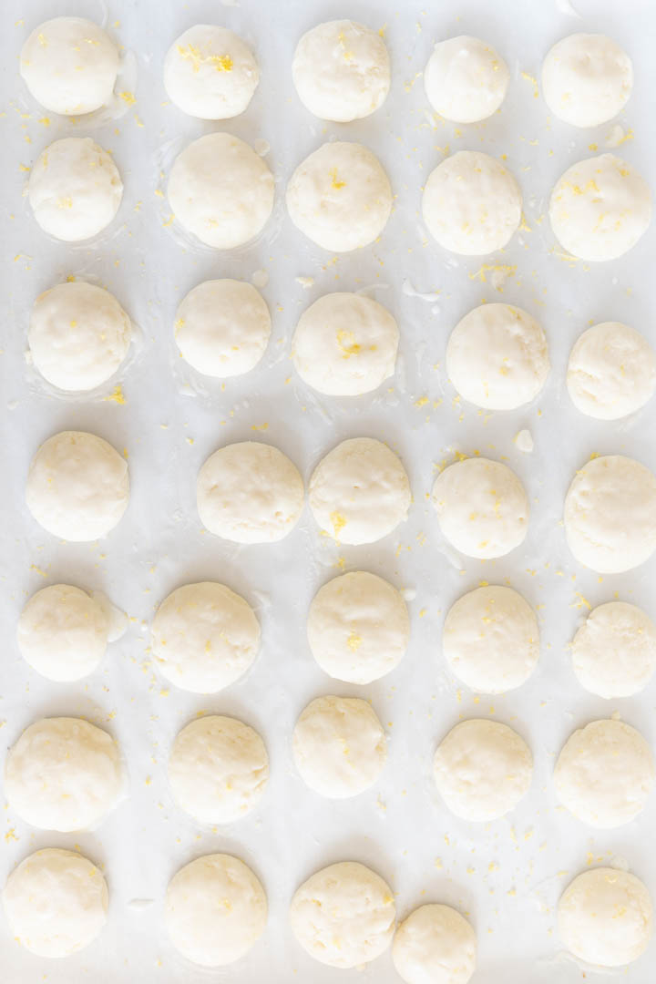 Lemon meltaway cookies lined in a grid on the counter. 