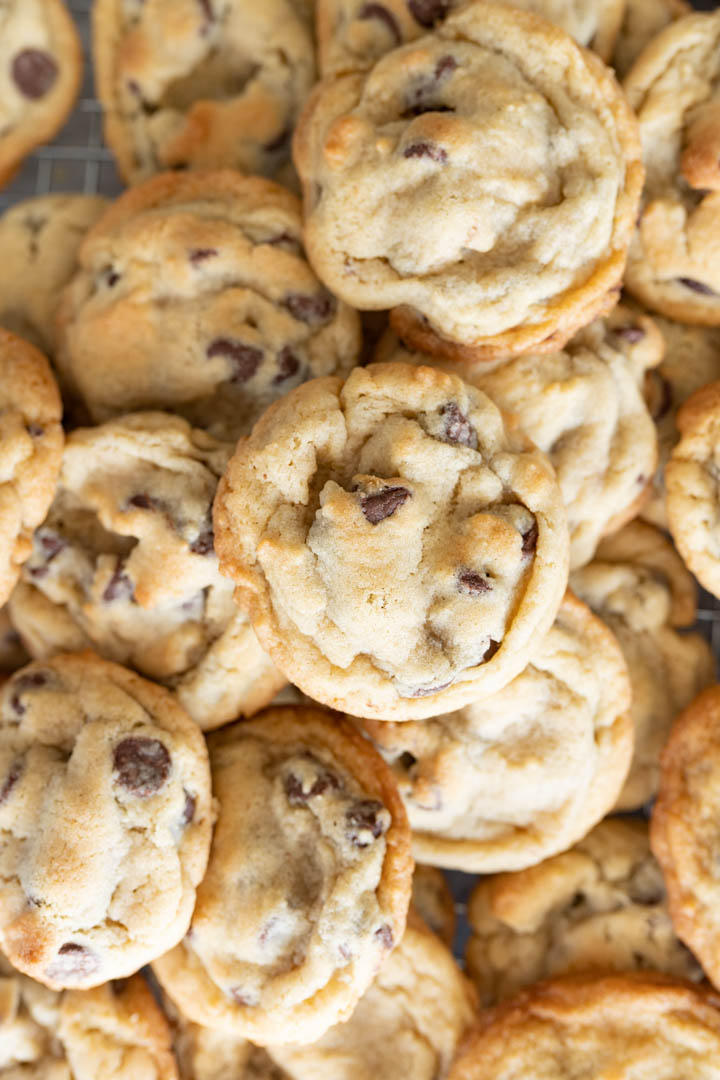 Close up of a pile of tollhouse chocolate chip cookies. 