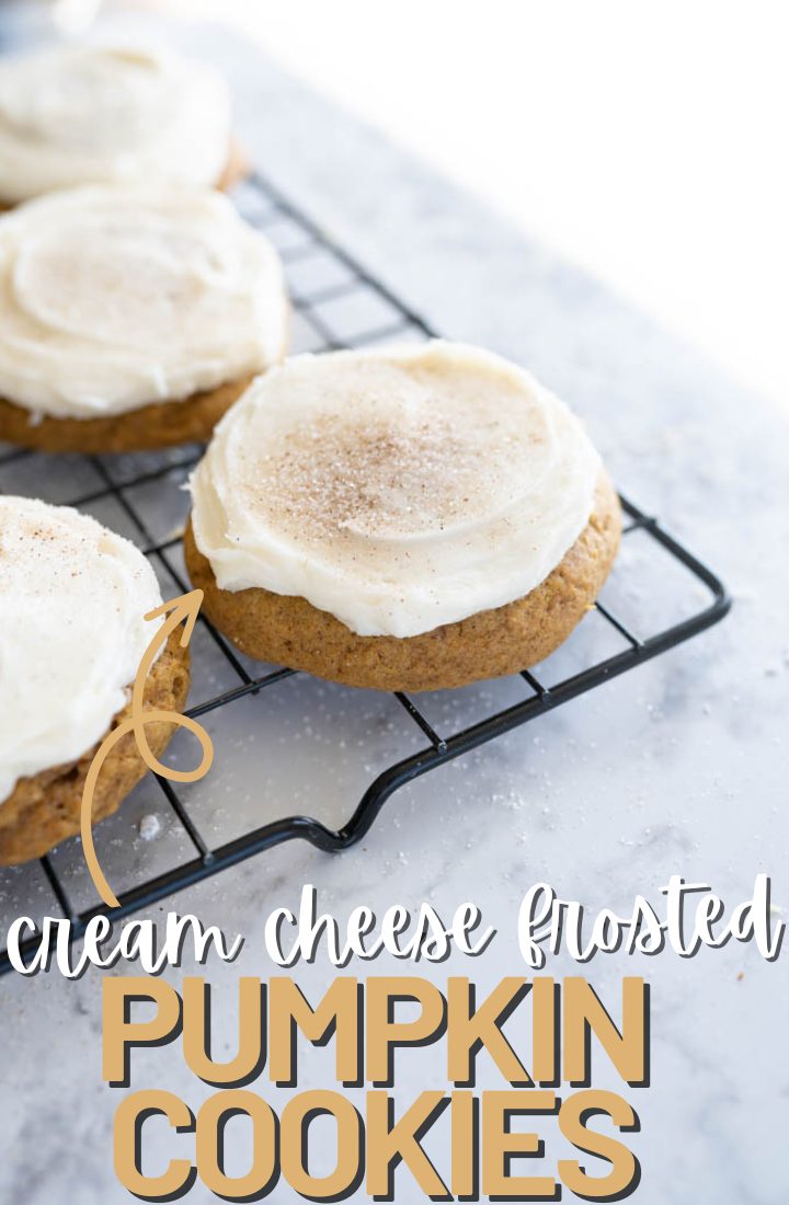 Angled image of 3 pumpkin cookies with cream cheese frosting on the corner of a wire cooling rack. On the bottom it says "cream cheese frosted pumpkin cookies" in text.