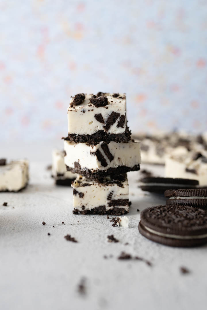 A stack of 3 oreo cheesecake bites on the counter. 