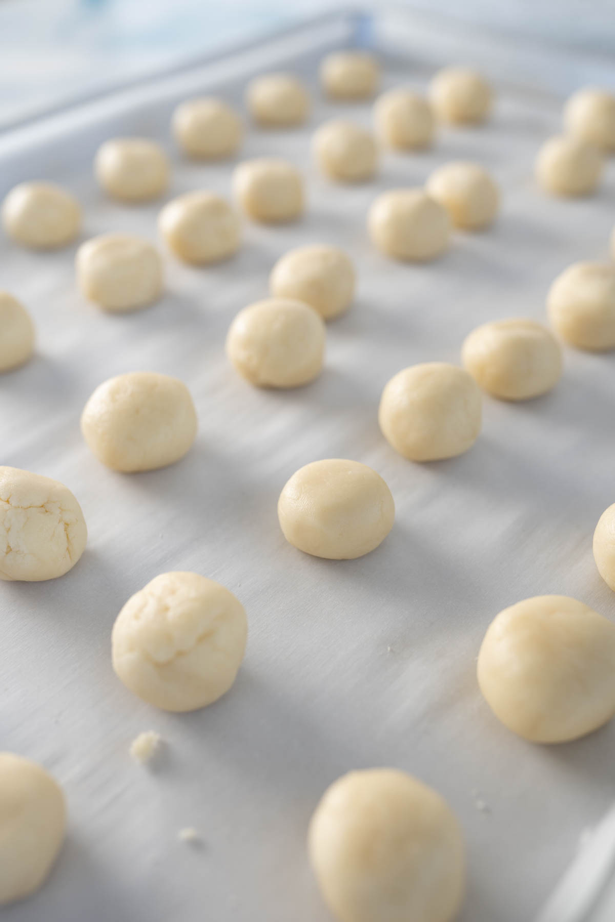 Aerial view of meltaway cookie dough on a cookie sheet preparing to be baked. 