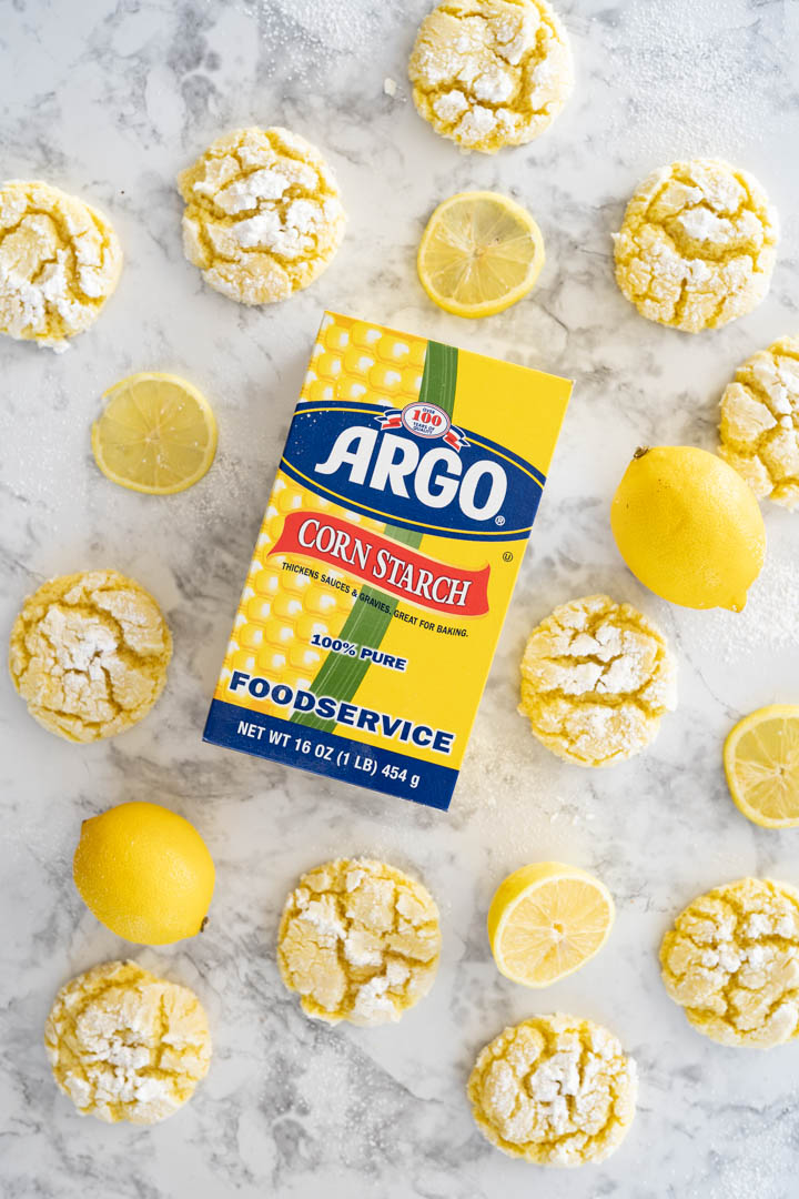 Aerial view of cookies surrounding a box of cornstarch. 
