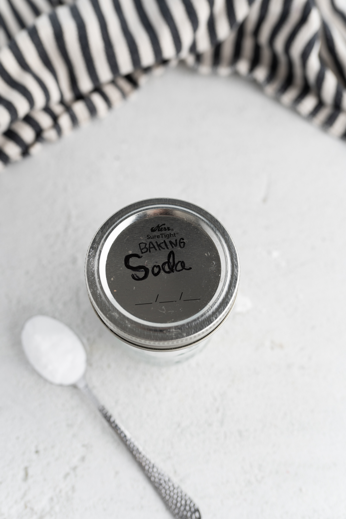 Aerial view of a mason jar labeled baking soda discussing baking soda substitutes. 