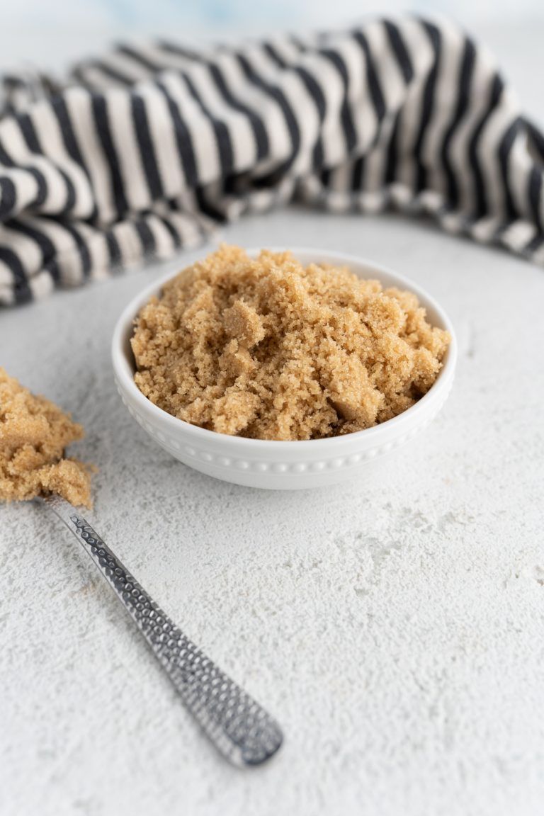A bowl of brown sugar on the counter.