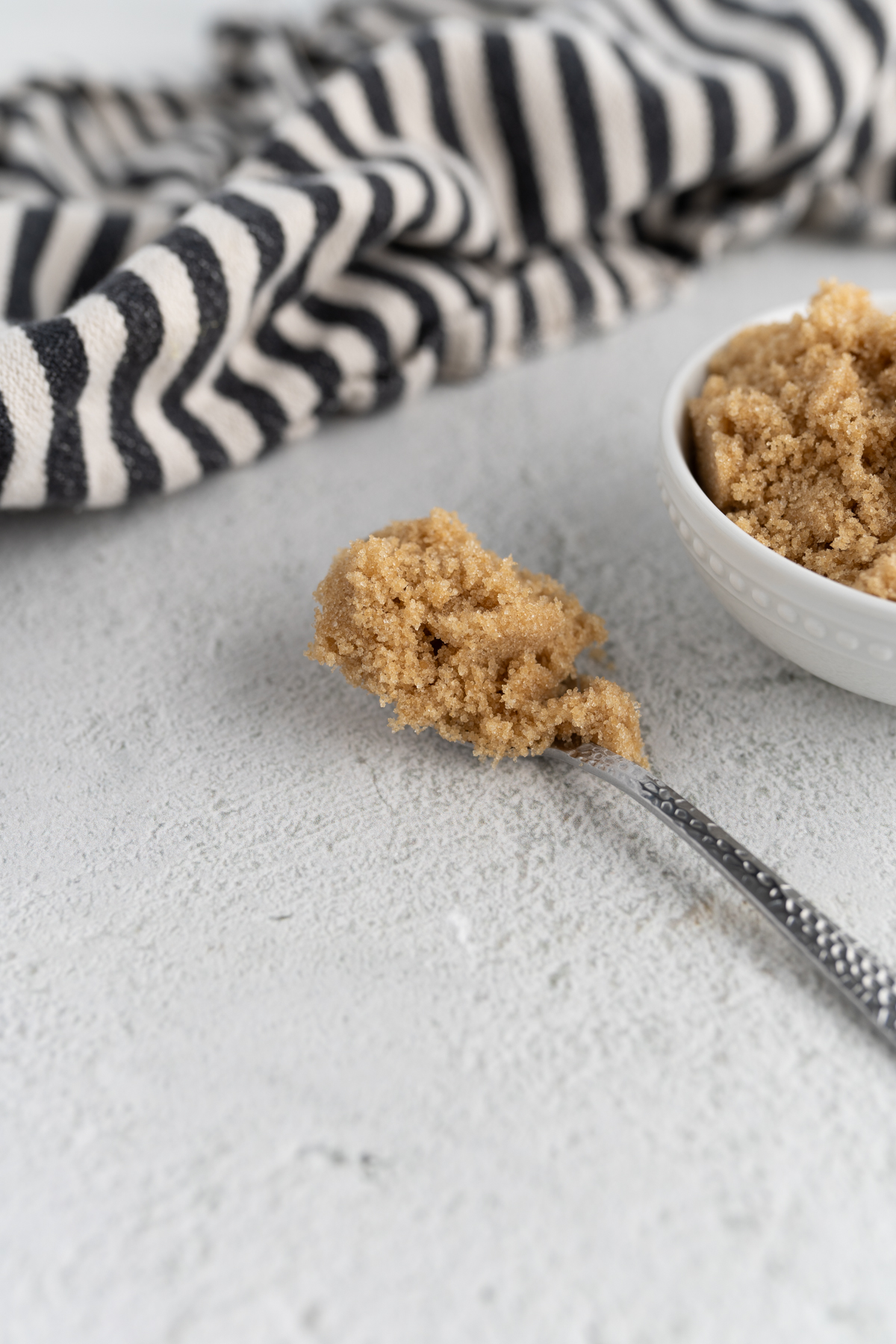 A close up of a spoonful of brown sugar. 