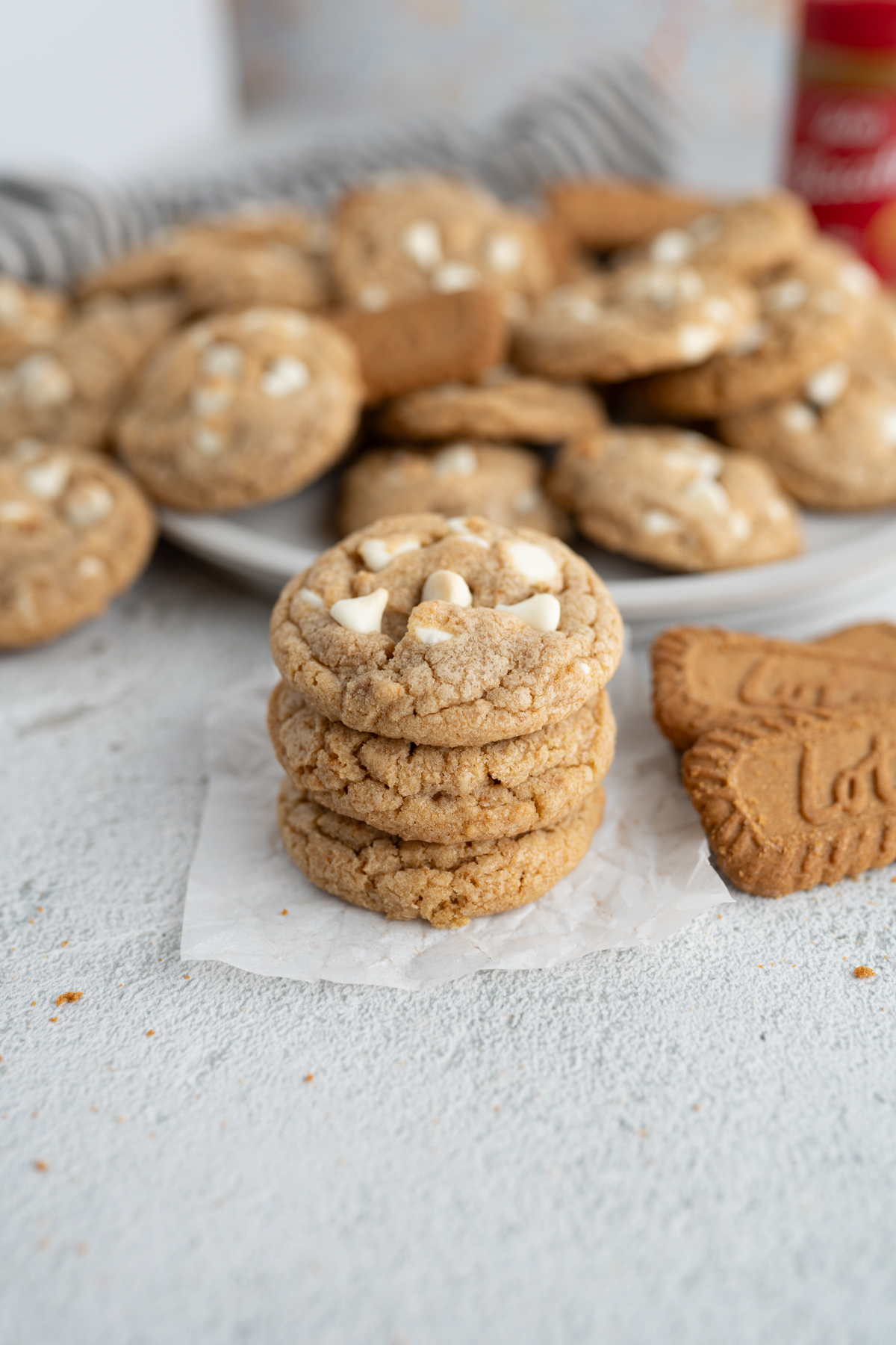 A stack of biscoff cookies with melty white chocolate chip cookies. 