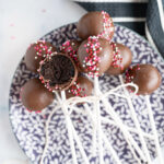 A plate filled with chocolate cake pops.