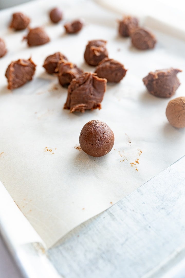 Chocolate truffle balls being rolled into shape. 