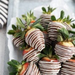 Image of chocolate covered strawberries drizzled with white chocolate.