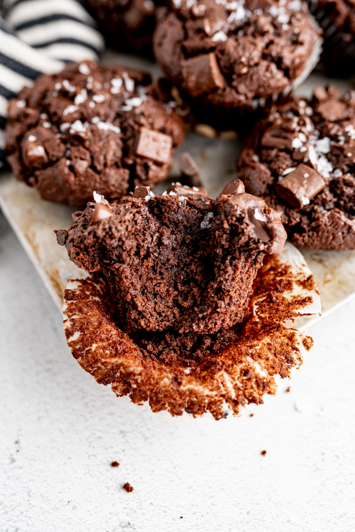 Image of a chocolate chunk muffin with a bite out of it. 