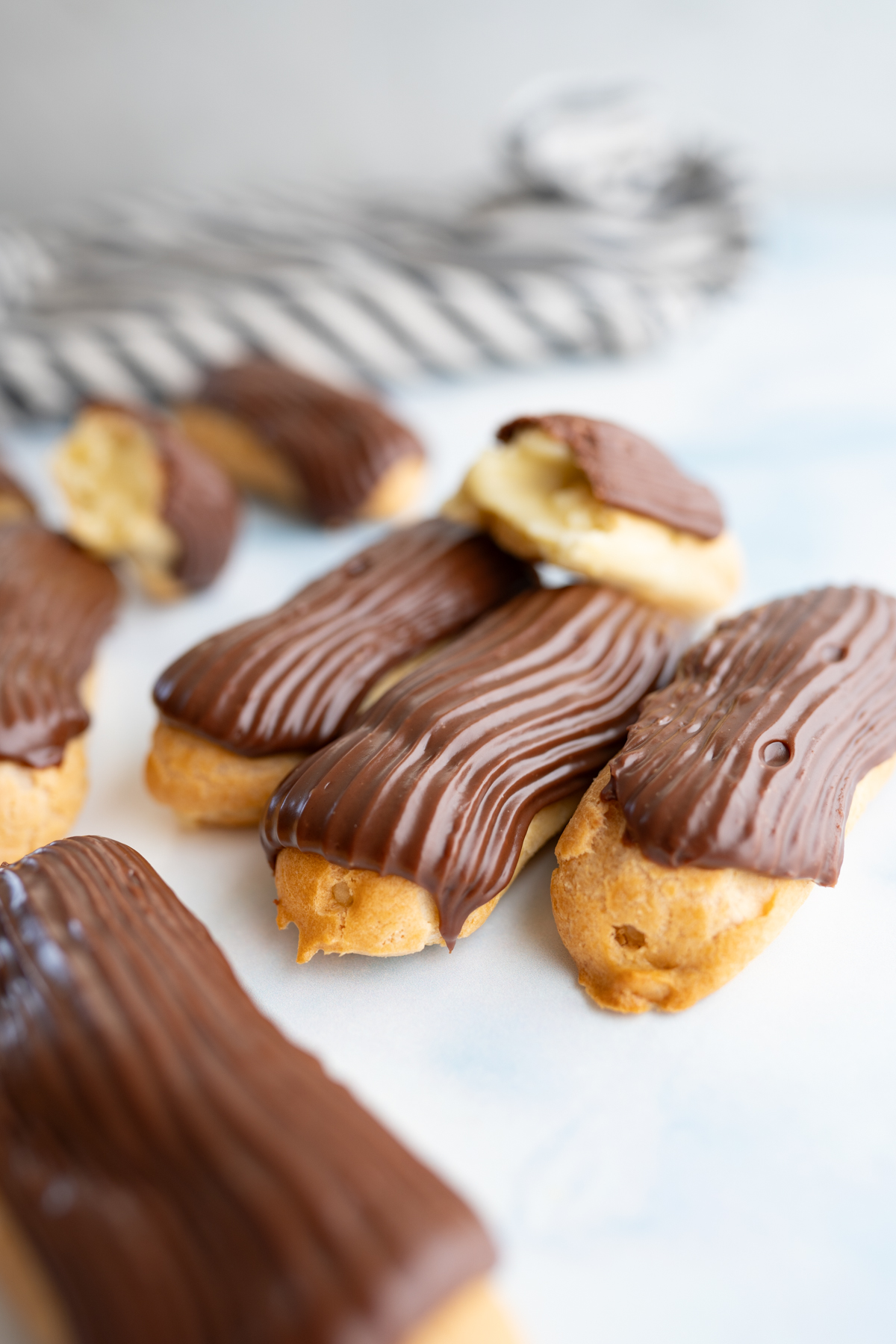 A pile of homemade chocolate eclairs. 
