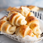 A bowl filled with homemade crescent rolls.