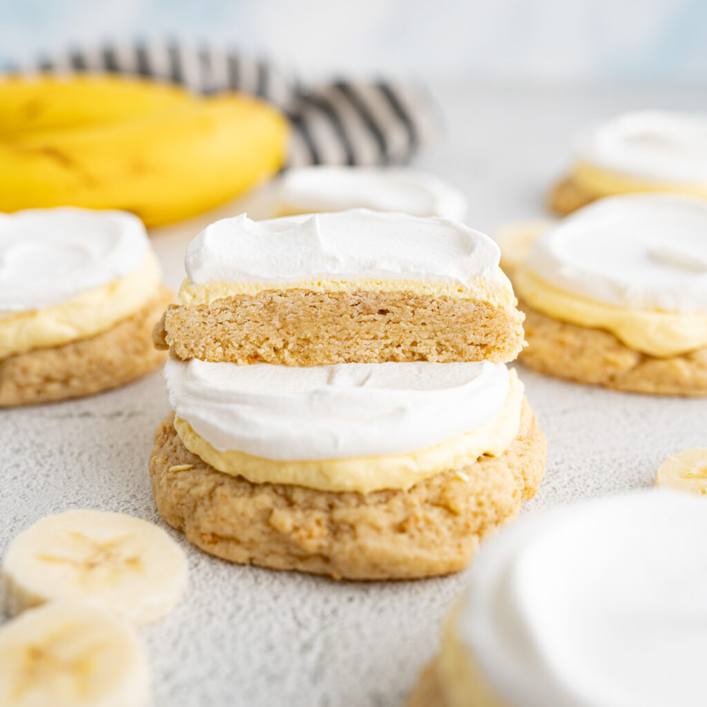 Banana cream pie cookies from Twisted sugar stacked on top of each other.