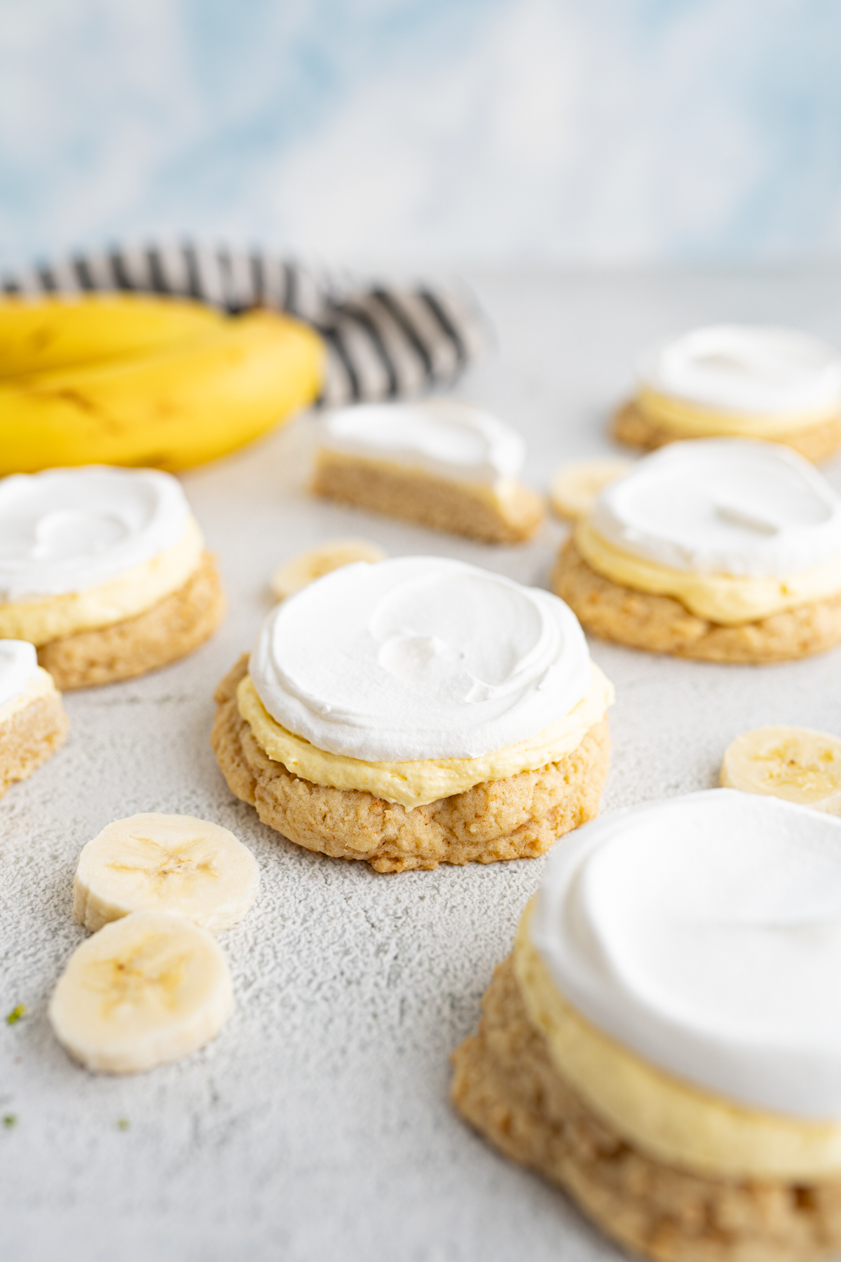 Side view of banana cream pie cookies spread out on the counter. 