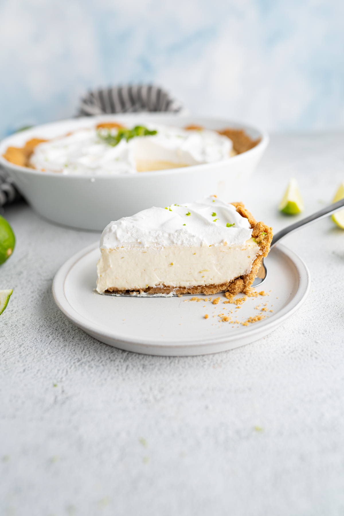 Side view of a slice of key lime pie on a plate. 
