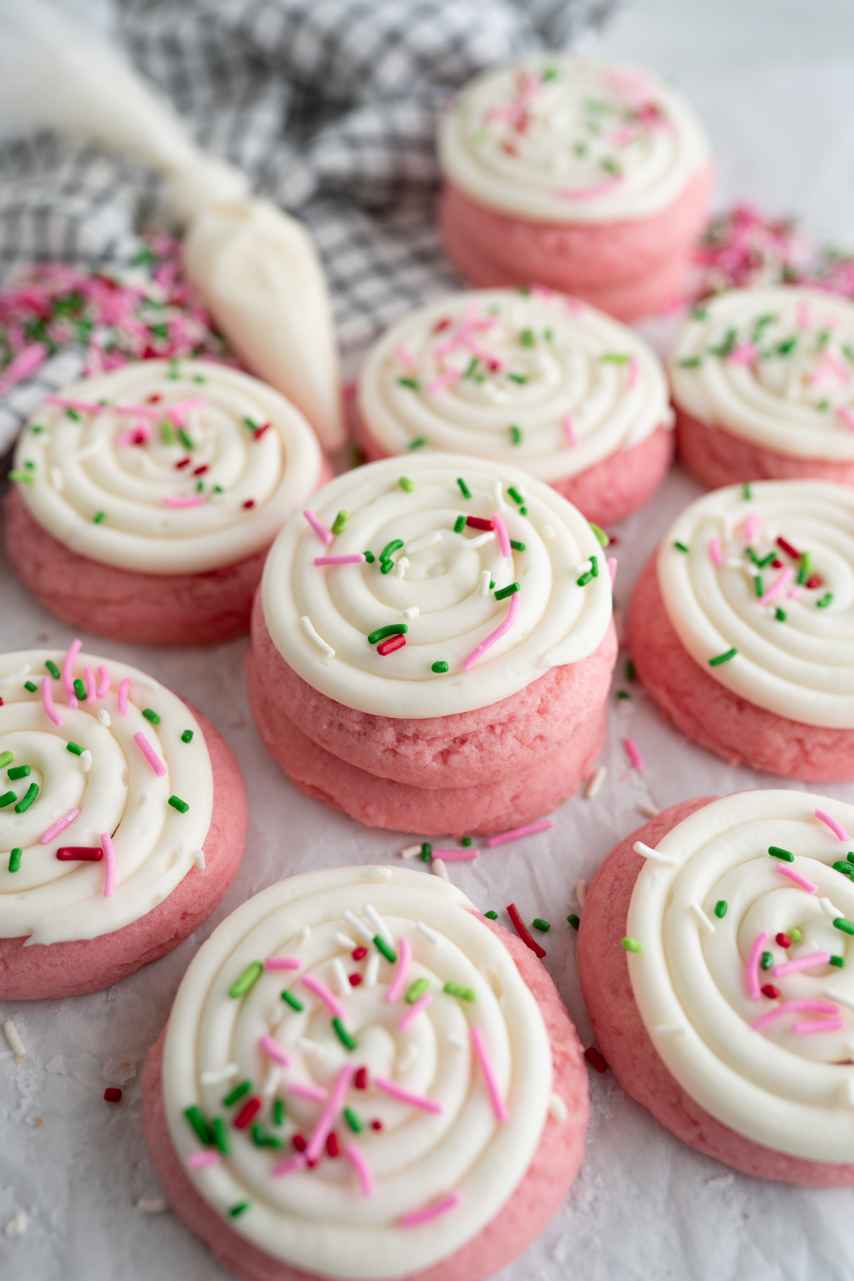 A pink velvet cookie stacked on another cookie. 