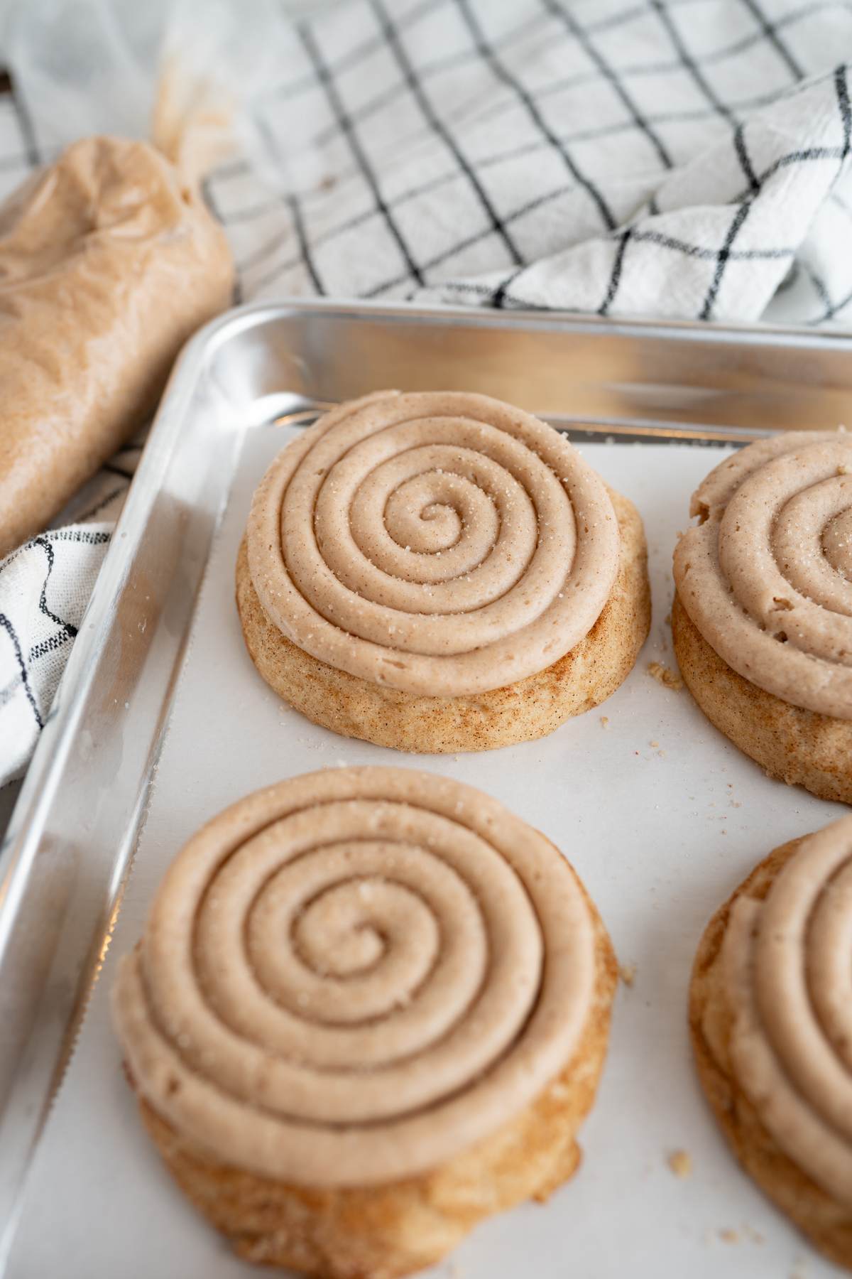 A mini crumbl churro cookie on a cookie sheet. 