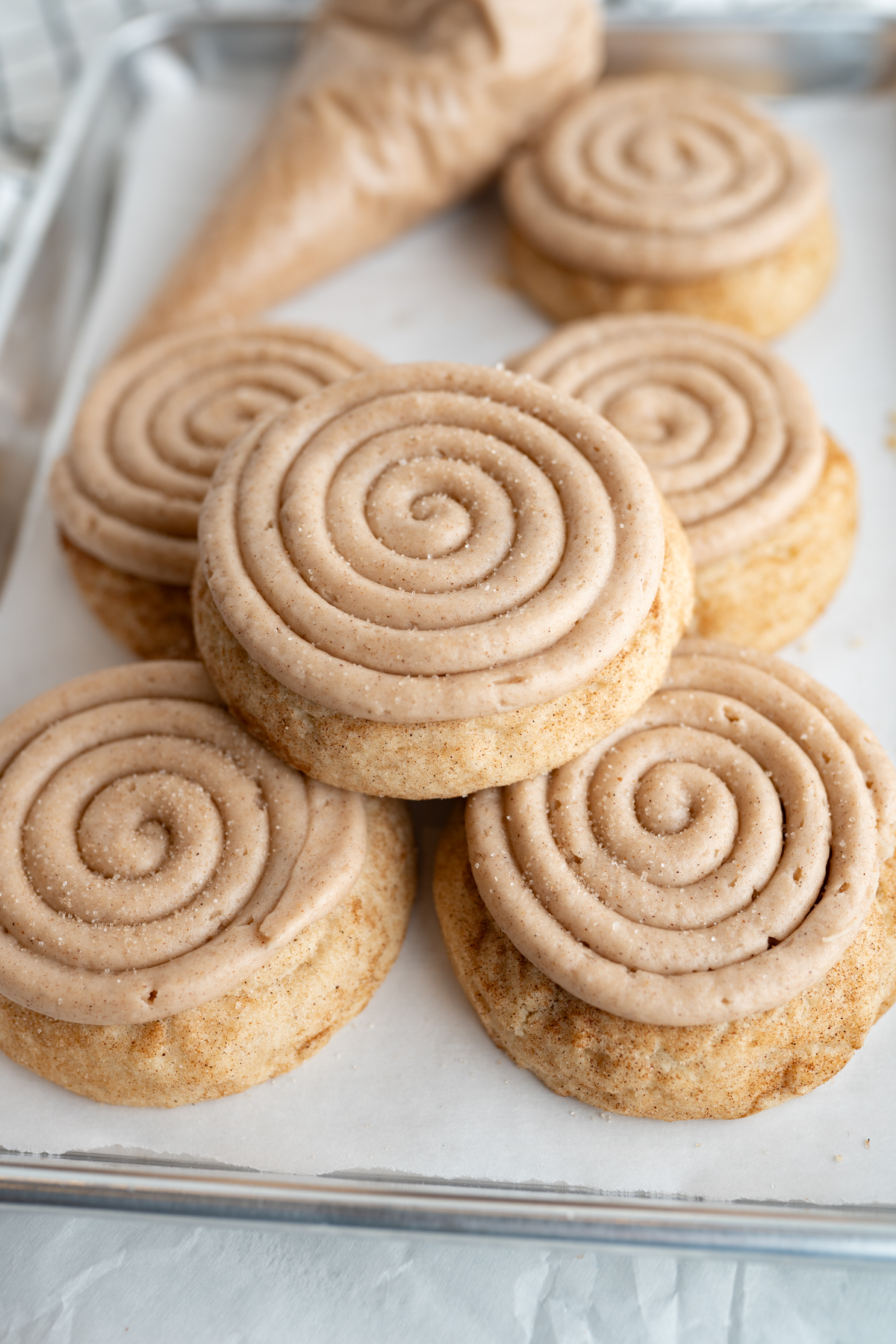 5 churro inspired cookies stacked together. Cinnamon sugar cookies piped with swirled frosting. 