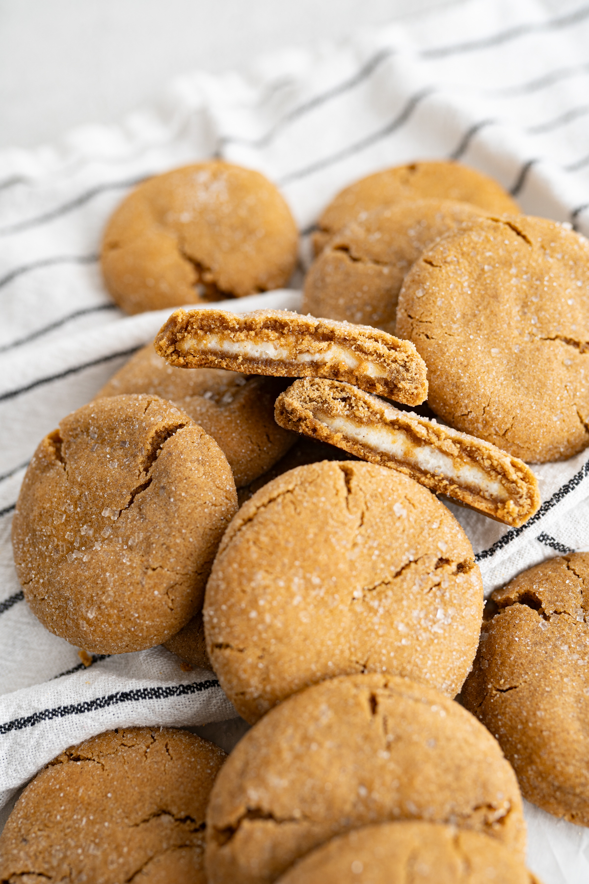 A gingerbread cookie cut in half to reveal cheesecake filling. 