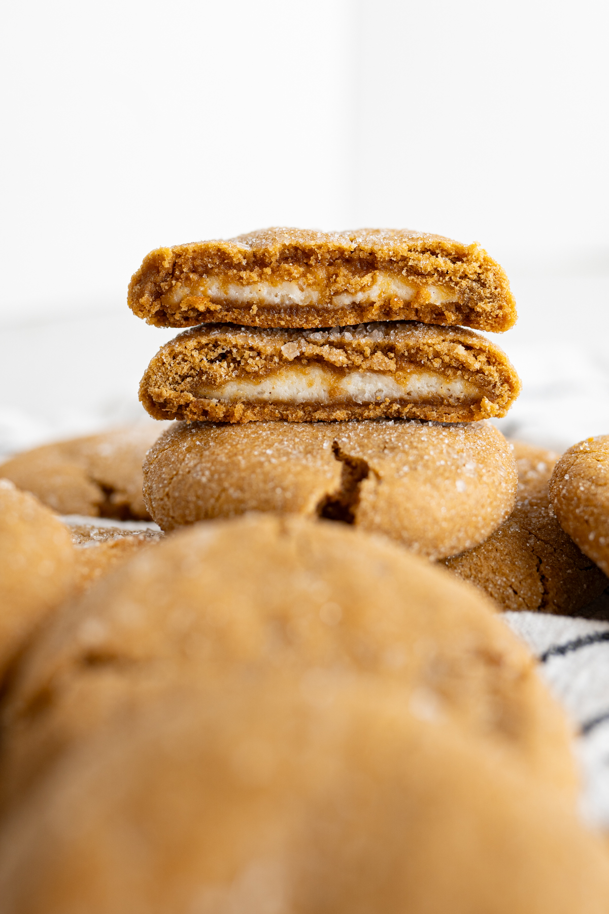 A mini cheesecake filled gingerbread cookie cut in half and stacked. 