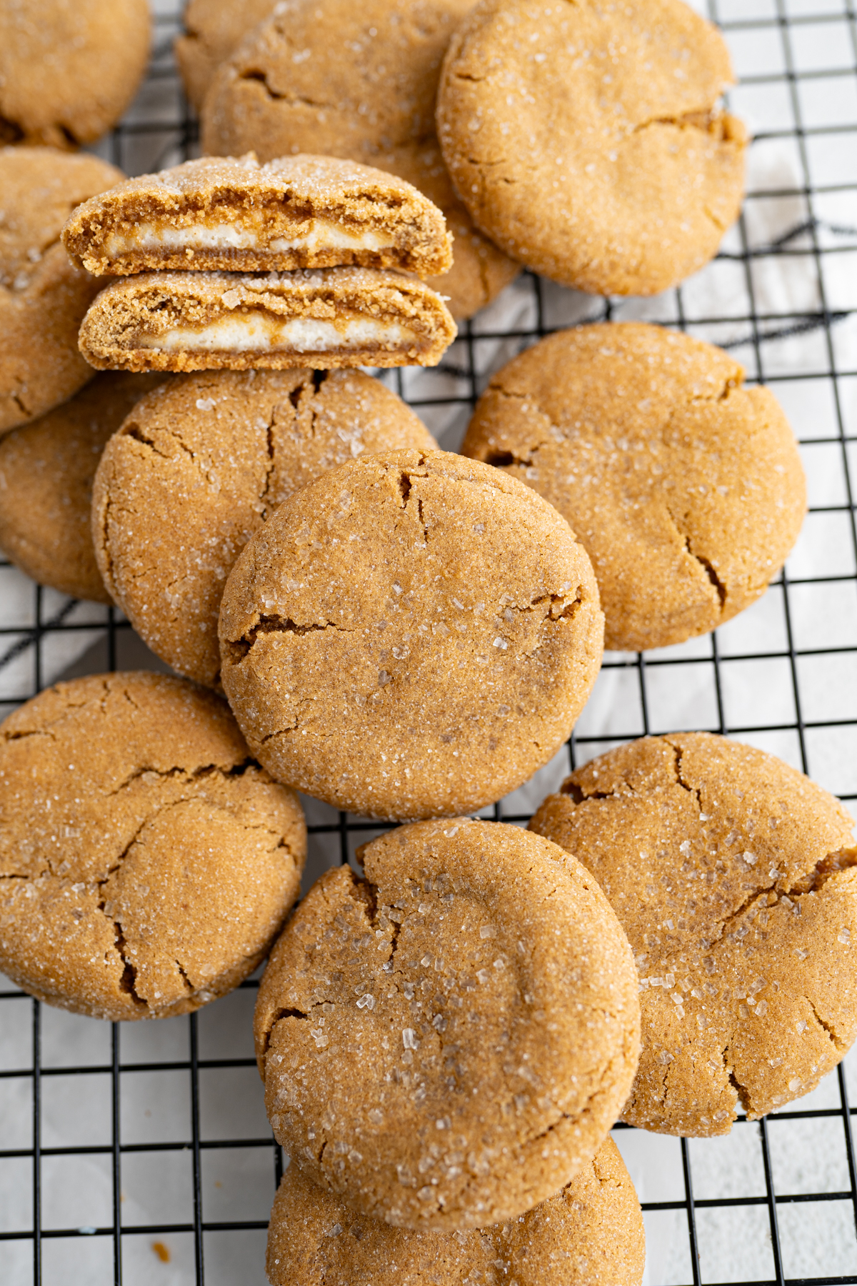 A pile of molasses gingerbread cookies on a cooling rack. 