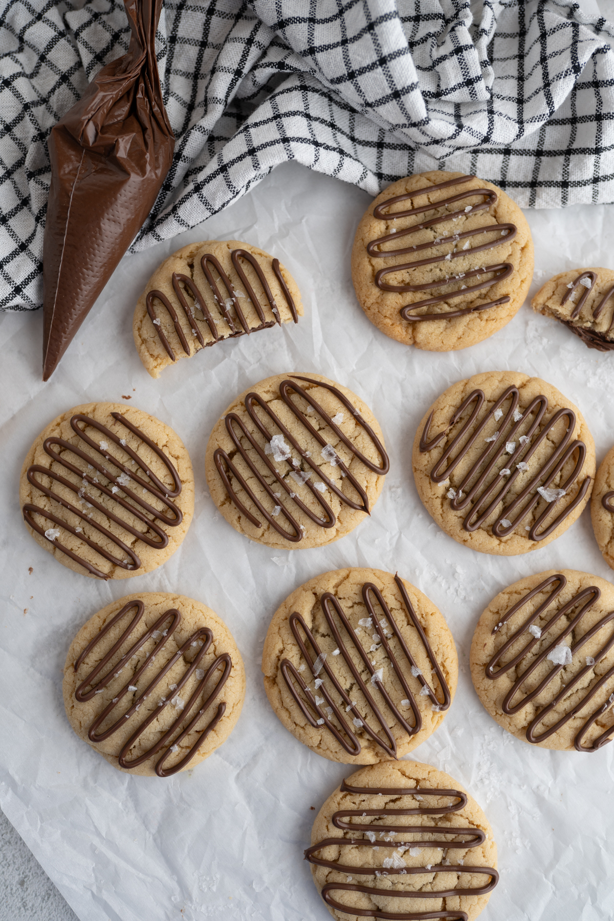 Catering size crumbl hazelnut sea salt copycat. Cookies are spread on the countertop. 