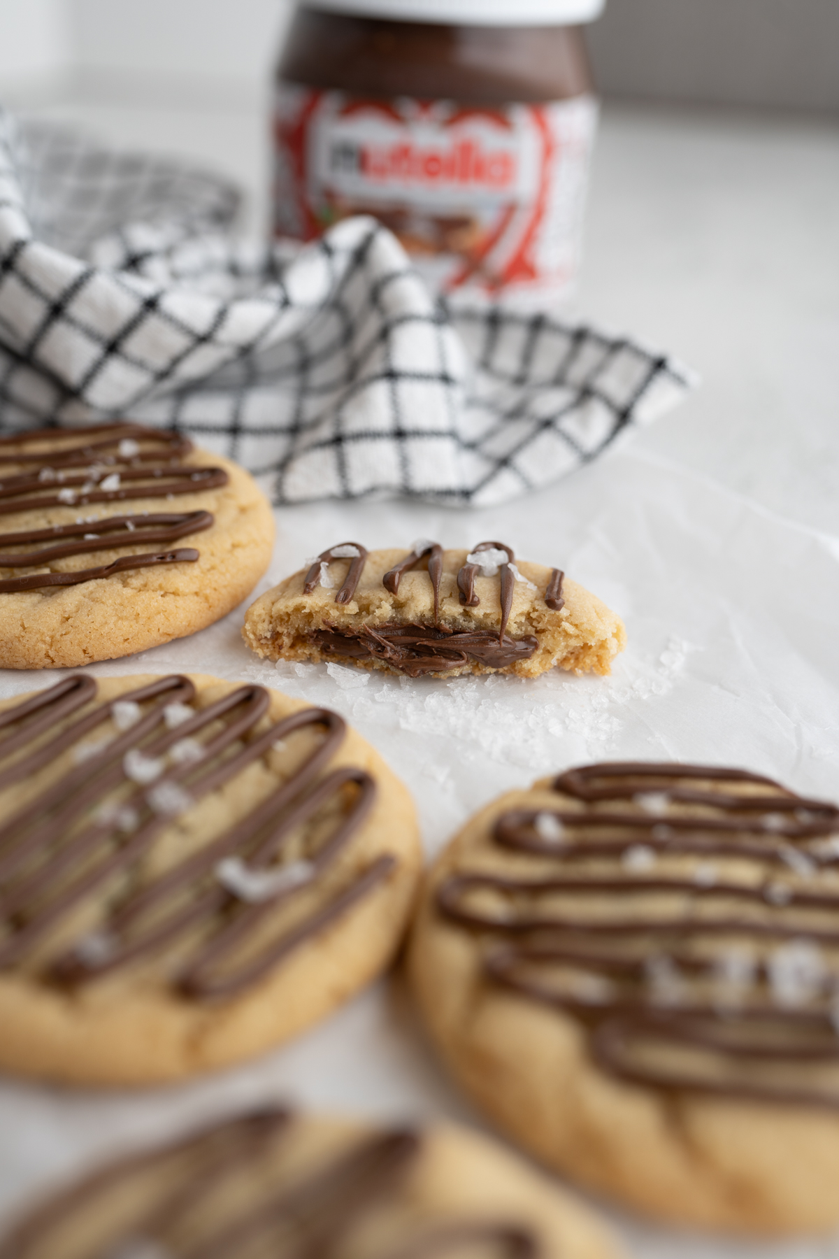 Nutella hazelnut cookie topped with flake salt cut in half. 