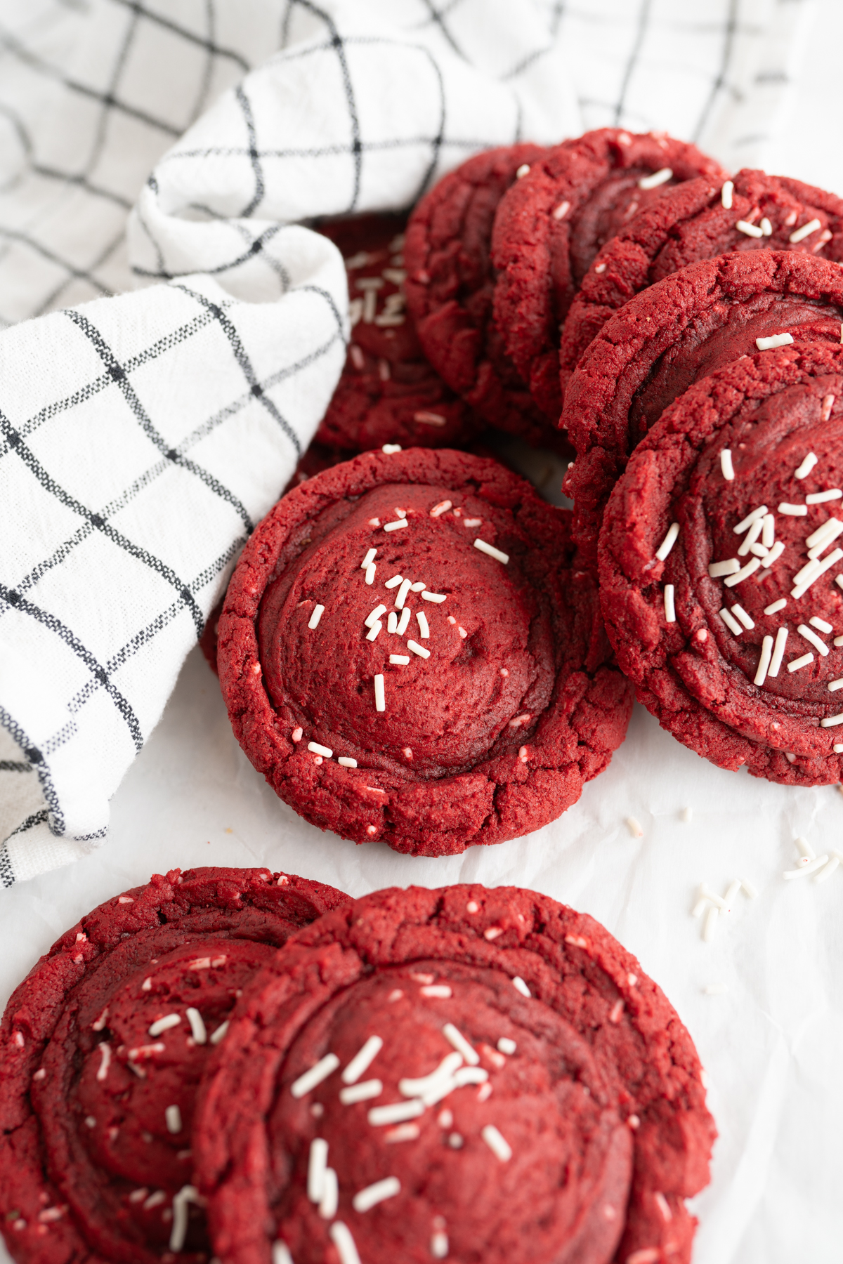 A pile of red velvet cake cookies on the counter. 