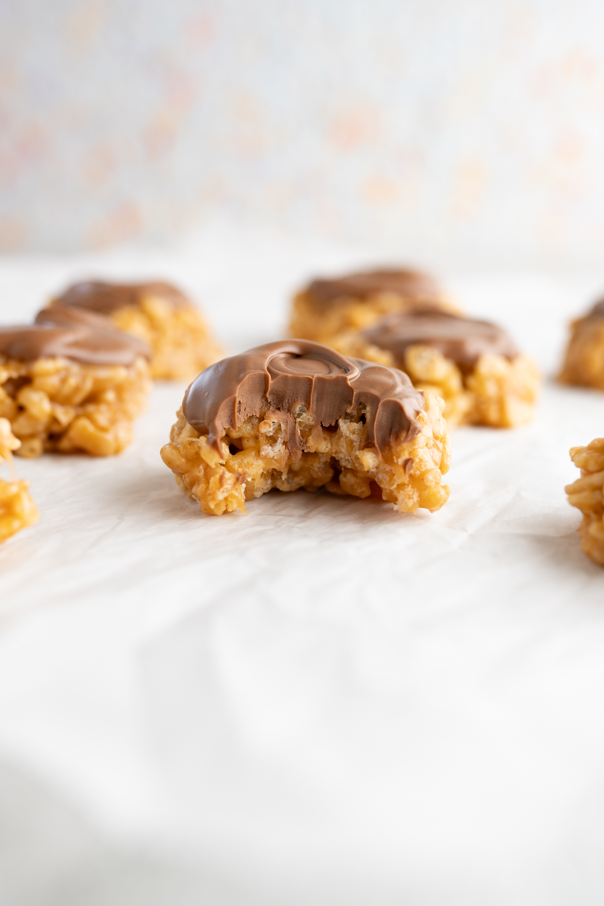 Close up of a scotcharoo cookie with a bite taken out of it. 