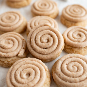 Catering size crumbl churro cookies scattered on the counter.