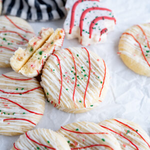 A mini sugar cookie filled with christmas tree cake buttercream.