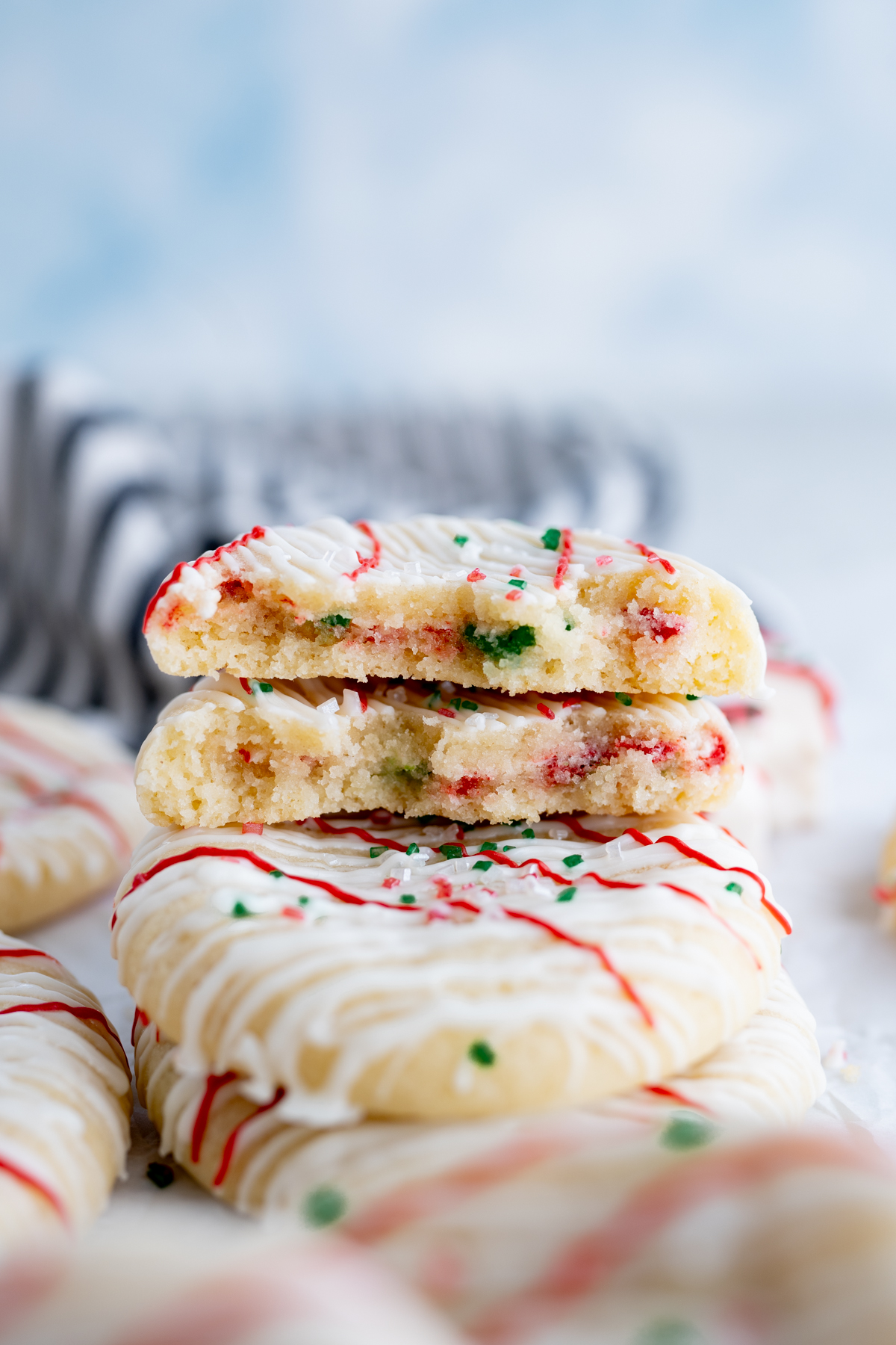 A christmas cookie cut in half to reveal christmas tree cake buttercream. 
